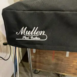 A black Mullen Guitar Dust Cover for a stool