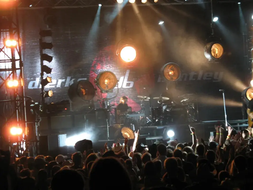 A group of people on stage at a concert.