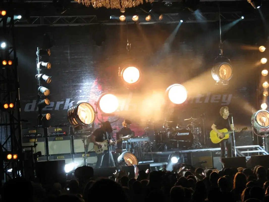 A group of people on stage at a concert.