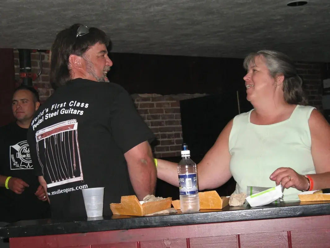 A man and a woman standing at a bar.