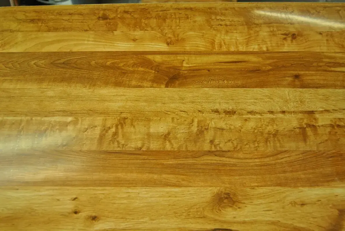 An image of a wooden table top in a kitchen.